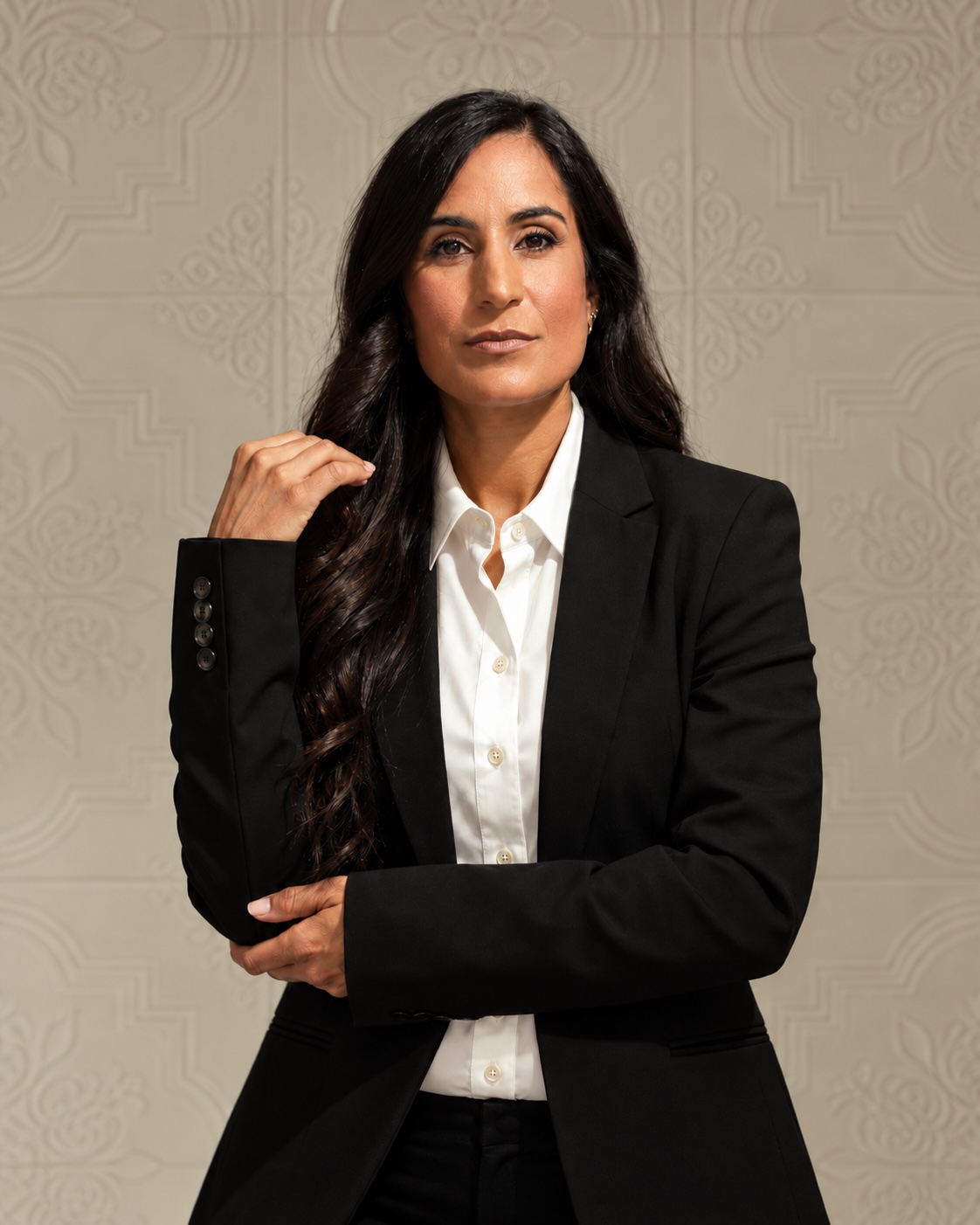 Dr. Remina Panjwani in a black suit and white shirt